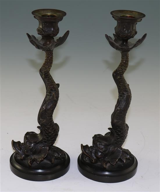 A pair of 19th century bronze candlesticks, modelled as dolphins, 10.5in.